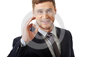 Businessman showing perfect sign.