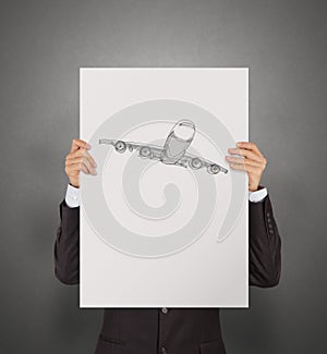 Businessman showing poster of hand drawn airplane