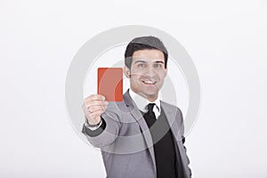 Businessman showing red card