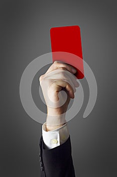 Businessman showing red card