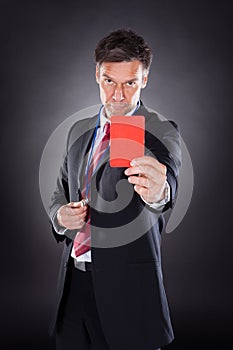 Businessman showing red card