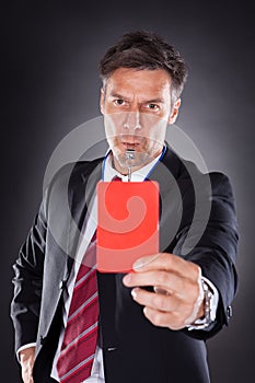 Businessman showing red card