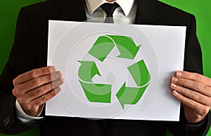 Businessman showing a sheet with the recycling symbol