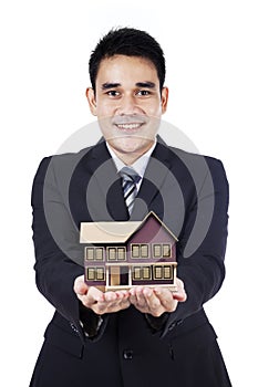 Businessman showing small house