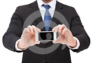 Businessman showing smartphone with blank screen
