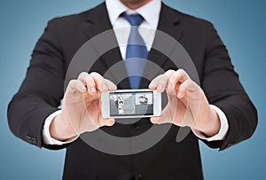 Businessman showing smartphone with blank screen