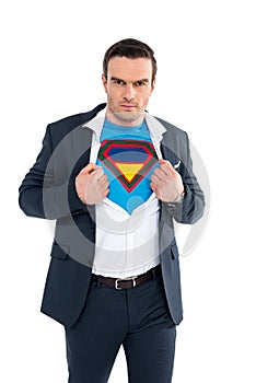 businessman showing superhero costume under suit and looking at camera