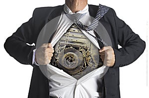 Businessman showing a superhero suit underneath machinery metal