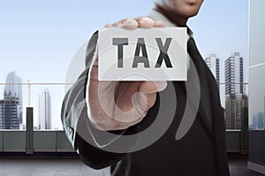 Businessman showing Tax text on white card