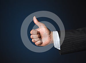 Businessman showing thumbs up