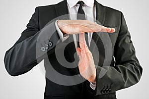 Businessman Showing Time Out Hand Sign