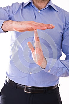 Businessman showing time out sign with hands.