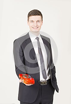 Businessman showing a toy car on his palm