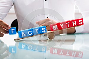 Businessman showing unbalance between facts and myths