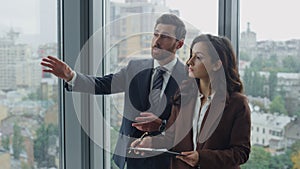 Businessman showing woman investor business project standing in office close up.