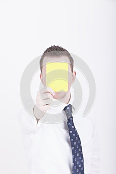 Businessman showing yellow card