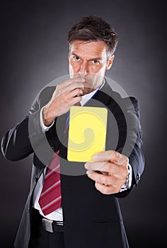 Businessman Showing Yellow Card