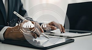 Businessman working with cloud computing and data security on digital tablet and laptop