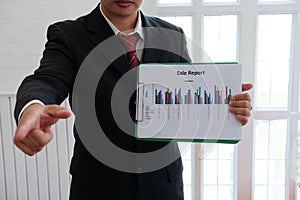 Businessman shows analytic financial accounting market chart graph report summary, business statistics performance concept