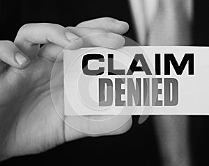 Businessman shows a card with text Claim Denied . Injury claim insurance concept