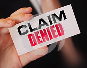 Businessman shows a card with text Claim Denied . Injury claim insurance concept