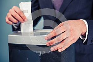 Businessman shredding documents