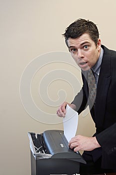 Businessman Shredding Documents photo