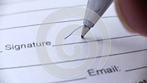 Businessman signing business contract agreement, close up of male hand with pen writing signature