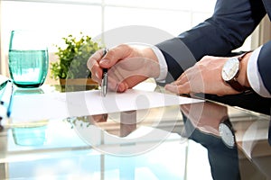 Businessman is signing a contract, business contract details.