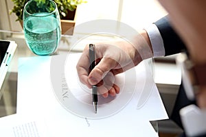 Businessman is signing a contract, business contract details.