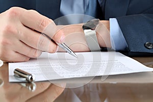 Businessman is signing a contract, business contract details