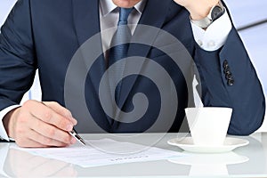 Businessman is signing a contract, business contract details