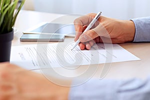 Businessman is signing a contract, business contract details