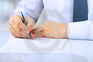 Businessman is signing a contract, business contract details