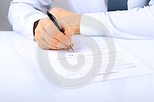 Businessman is signing a contract, business contract details