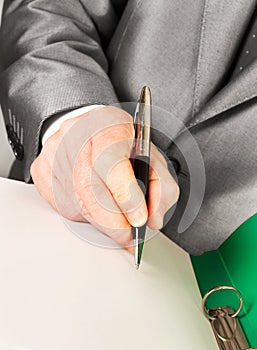 A businessman signing contract with a pen