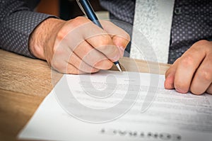 Businessman is signing a contract to conclude a deal