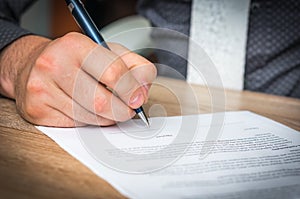 Businessman is signing a contract to conclude a deal