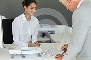 Businessman signing employee sheet