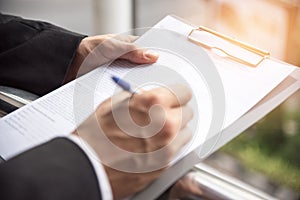 Businessman is signing at the sign paper, Business agreement concept, selective focus on left heand