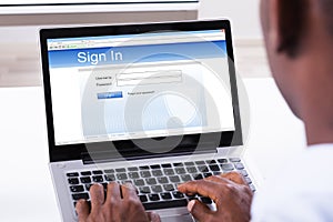 Businessman Signing In The Website On Laptop