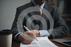 Businessman signs contract investment professional documents with a pen making the signature. Financial and insurance, job