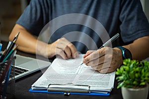 Businessman signs contract investment professional documents with a pen making the signature. Financial and insurance, job