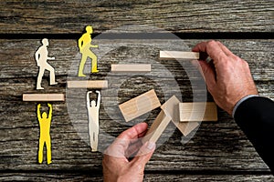 Businessman with silhouette people helping others climbing wooden stairs