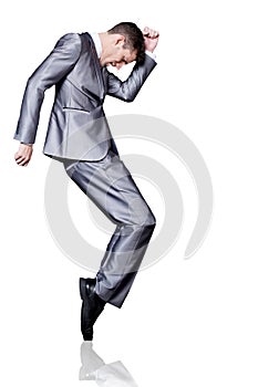 Businessman in silver suit dancing. Isolated.