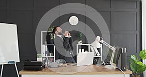 Businessman singing and dancing at office