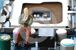 Businessman sit on a computer motherboard.