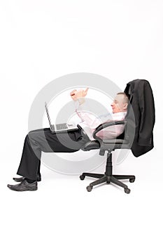 Businessman sitting in an armchair with a laptop.