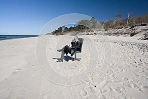 Businessman sitting on beach