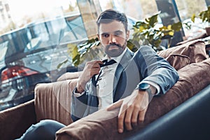 Businessman sitting in a business center restaurant untighten tie